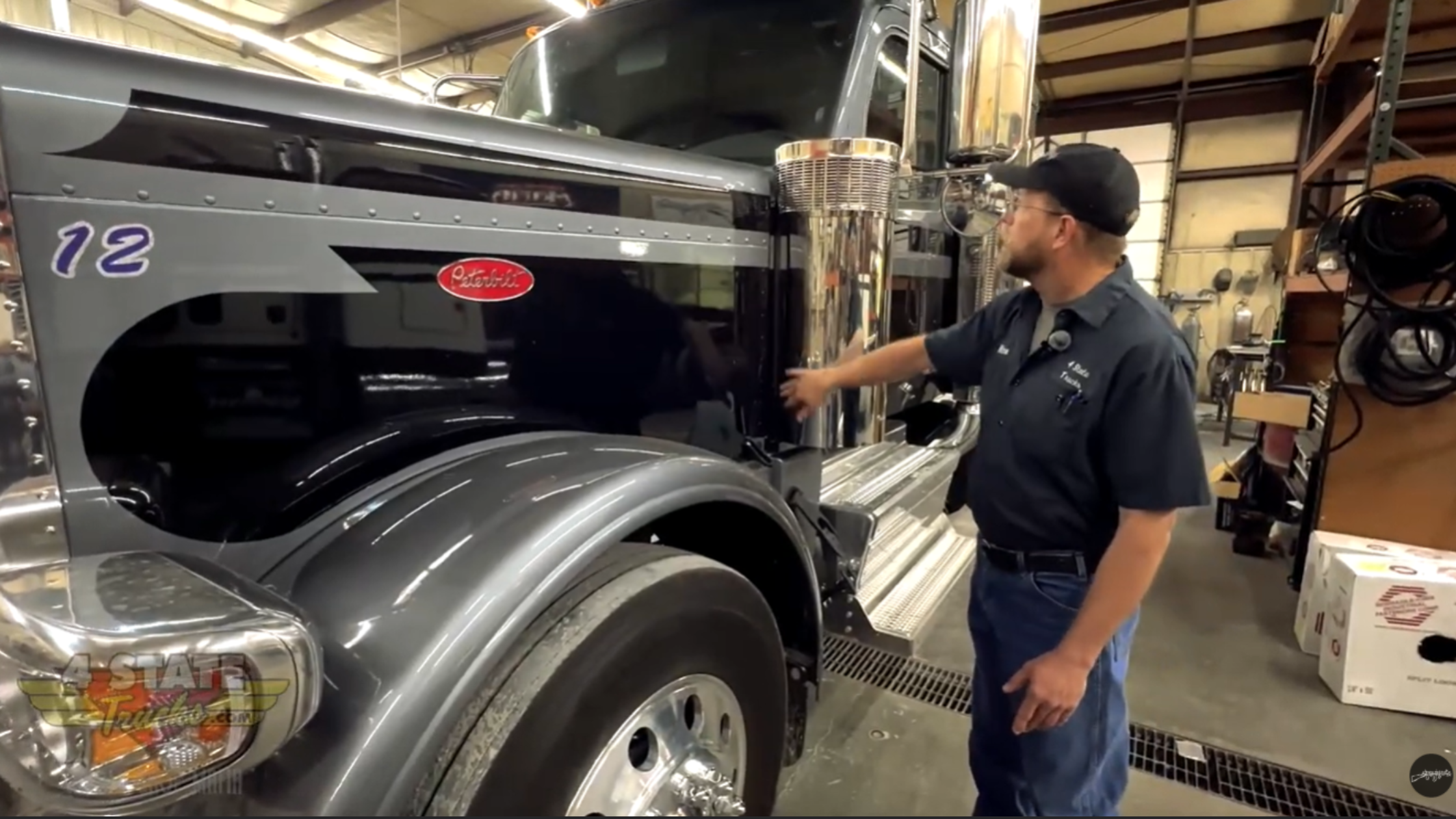 Factory air breather assembly mounted behind cab on Peterbilt 589 showing clamp brackets and vertical canister design.